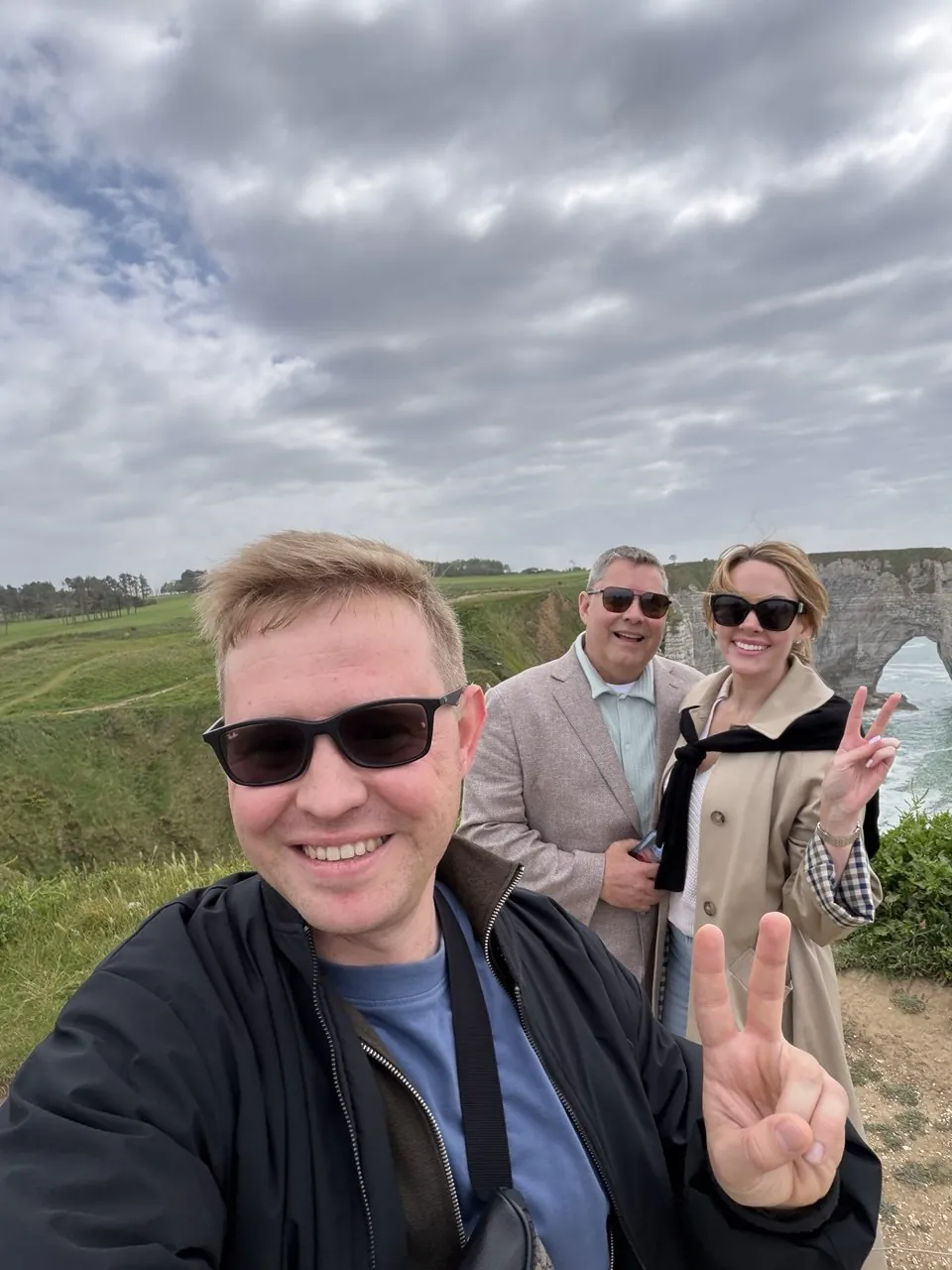 Smiling ProTours guests taking a selfie in Étretat
