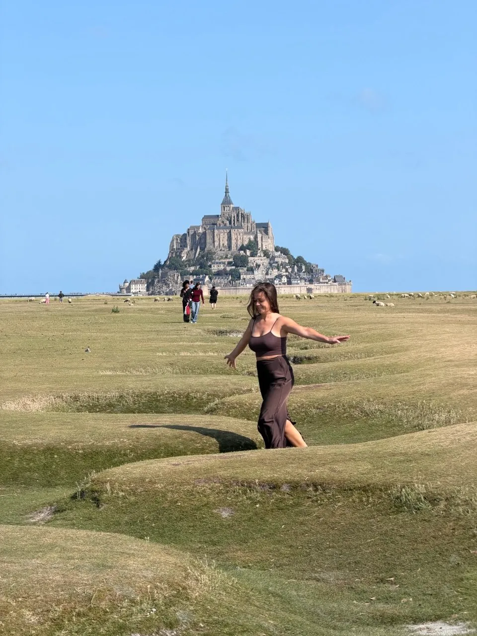 A ProTours guest walking through the fields near Mont Saint-Michel