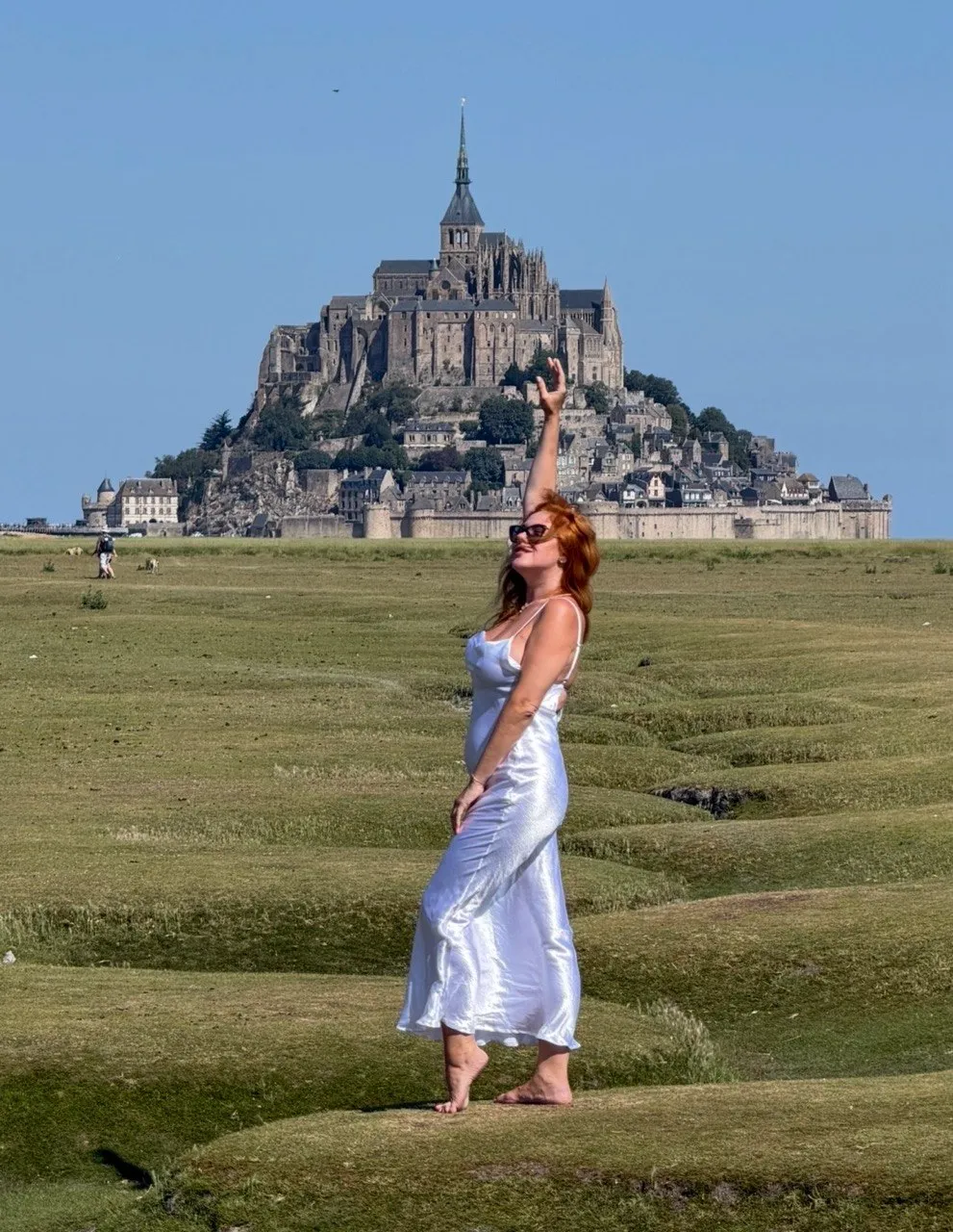 A ProTours guest posing with Mont Saint-Michel behind her